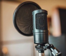 recording microphone setup in front of a pop filter with a blurred background